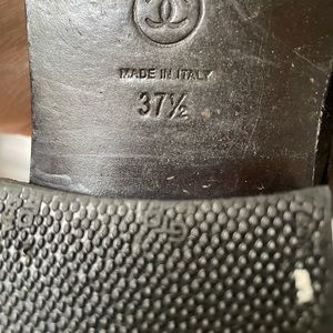 Black metallic chanel lace up boots.